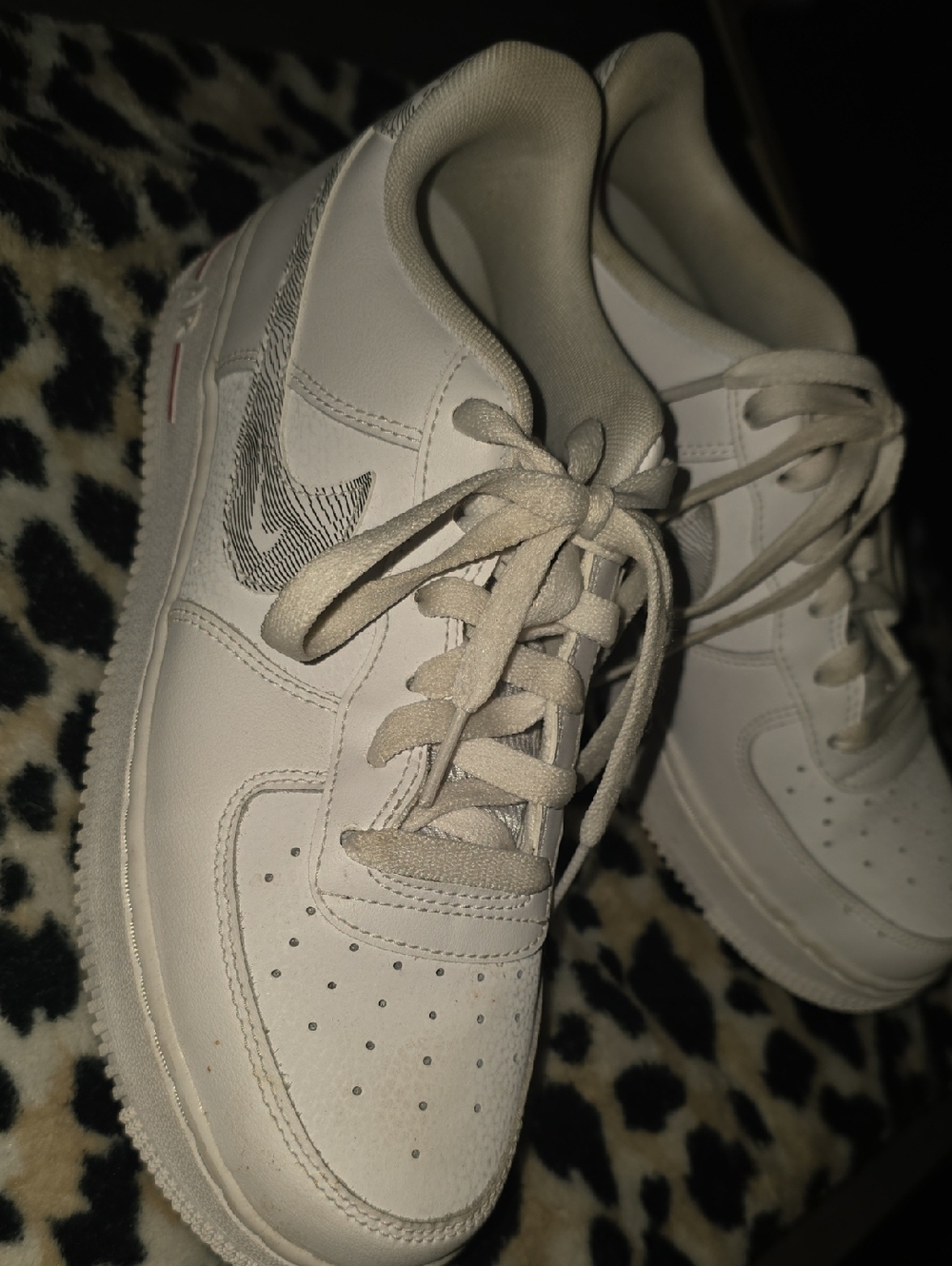 Nike White Low-Top Sneakers with Patterned Swoosh